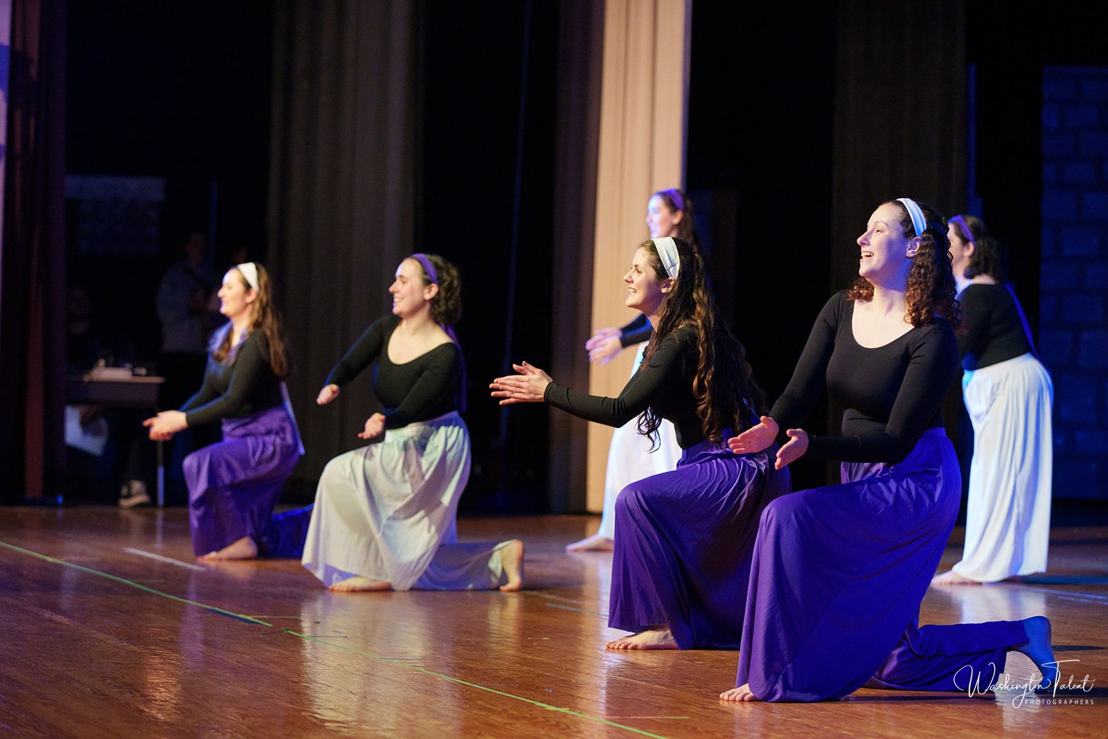 Members of Avirah perform on stage.