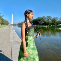 Ruka Ayele stands by the reflection pool with the Washington Monument in the background.