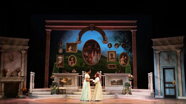 Actors playing Emma Woodhouse and Harriet Smith talk on stage.