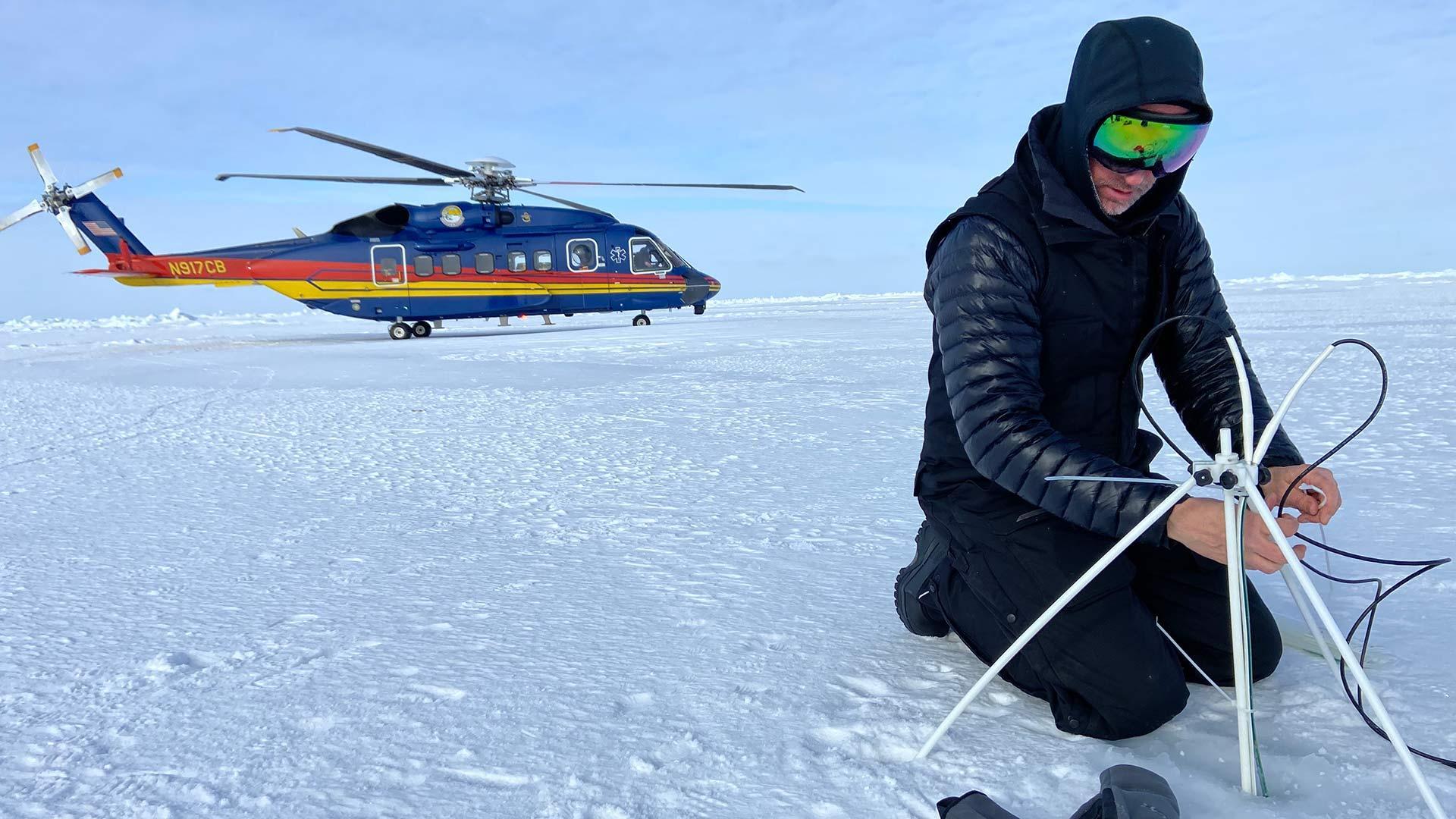 Assistant Professor of Art Cy Keener places a tracker on arctic ice, providing scientific data and material for his art simultaneously.