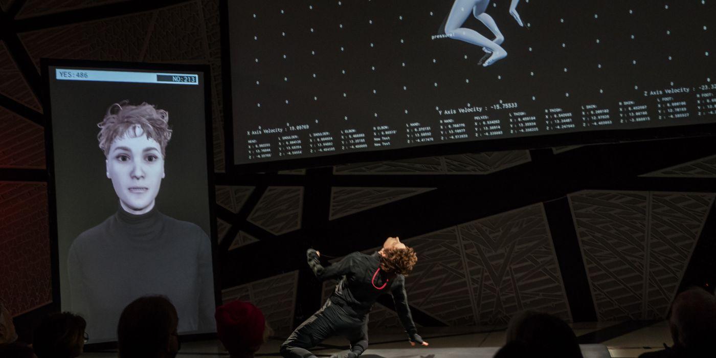 A dancer's moves are reflected in a screen above the dancer.