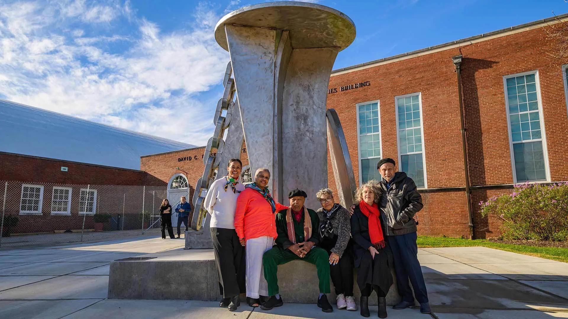 David Driskell's daughters and past and present Driskell Center staff pose on Thursday with sculptor Melvin Edwards in front of the newly unveiled artwork.