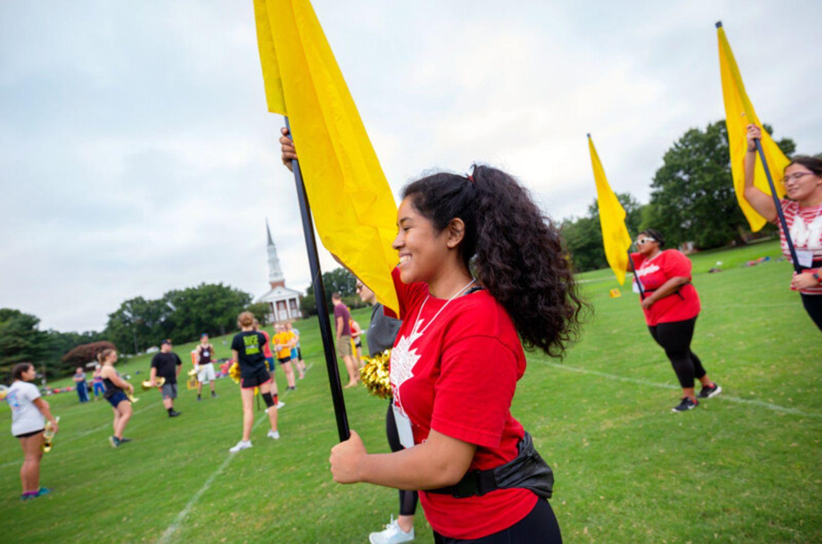 The Spring Color Guard practices with flags outside.