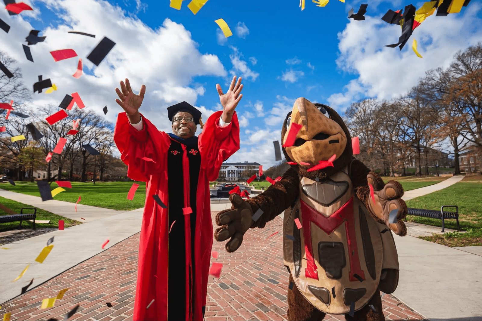 President Pines and Testudo celebrate graduates,
