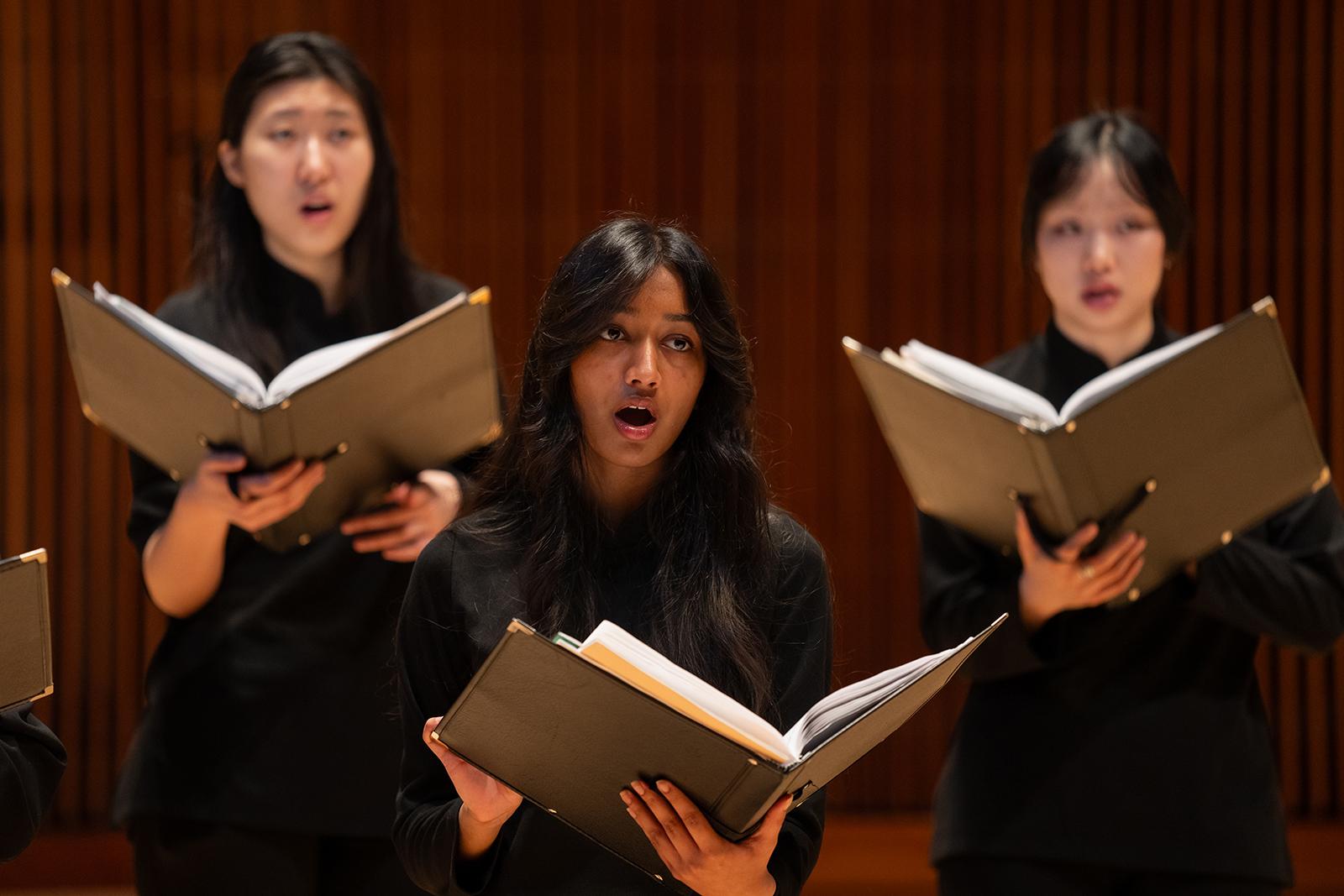Choral students perform on stage.