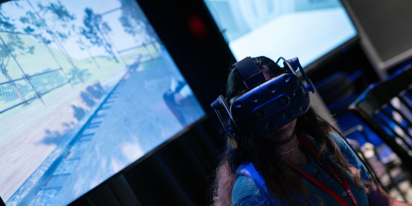 A student wearing virtual reality glasses experiences an immersive media project.