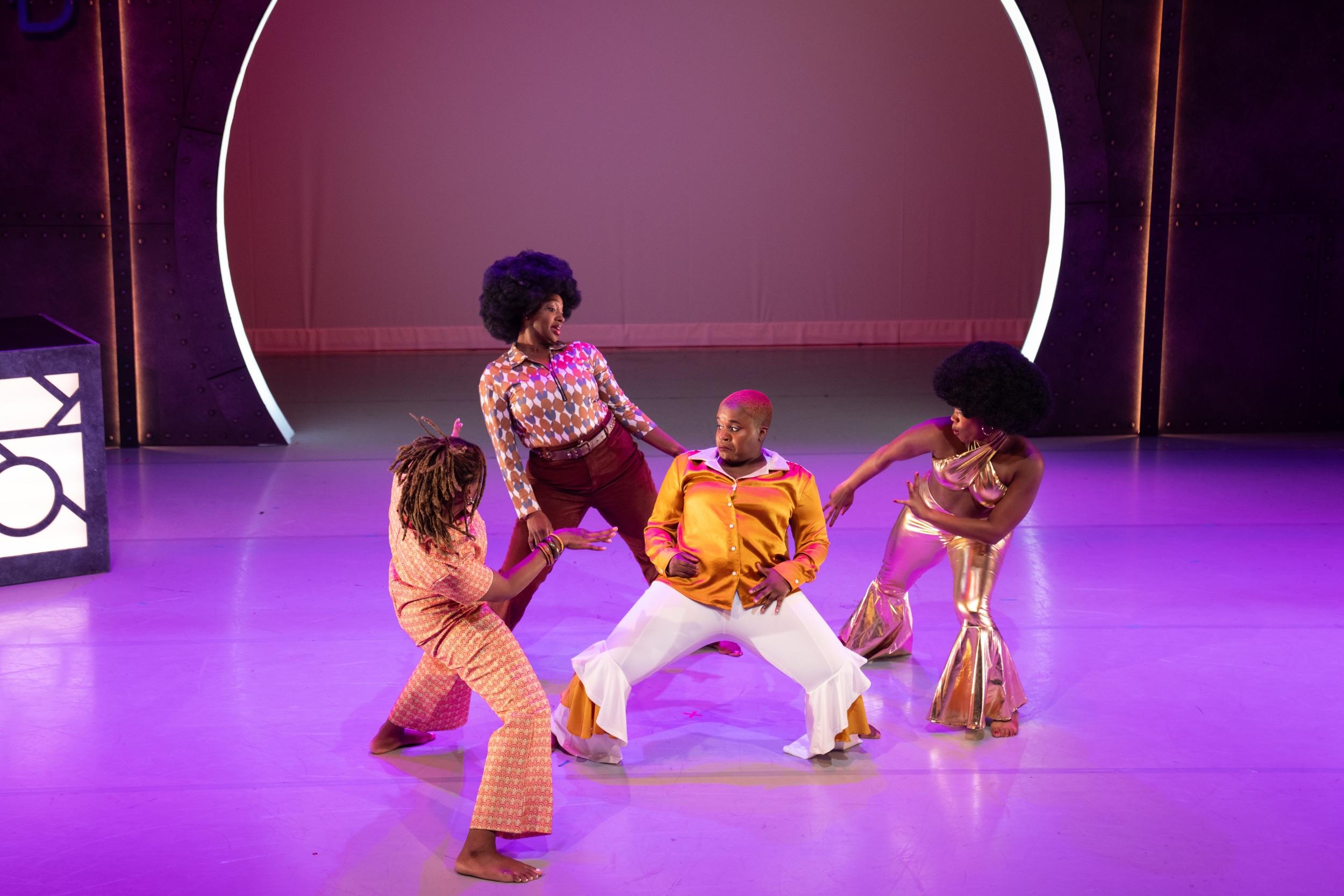 Dancers perform on stage.