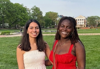 Rashi Maheshwari and Lisa Osei pose for a summer photo on McKeldin Mall.